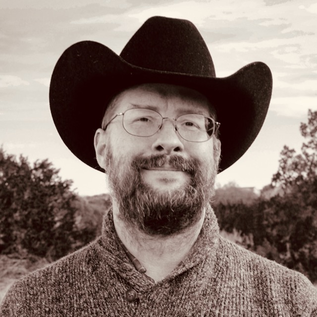 Photo of Steven R. Loomis — wearing a black felt western hat